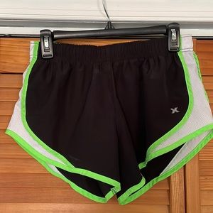 Women’s black athletic shorts with neon green detail
